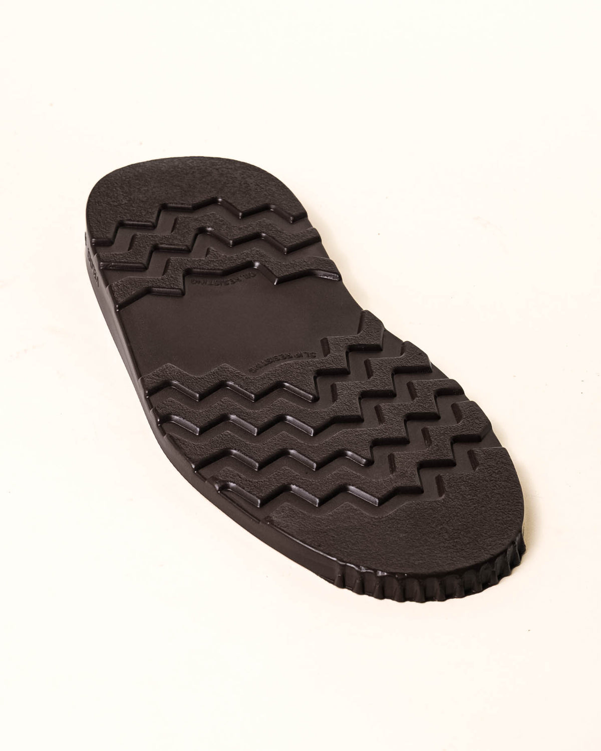 Brown wedge with tread showing with white background.